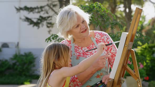 Granddaughter and grandmother painting on canvas 4k