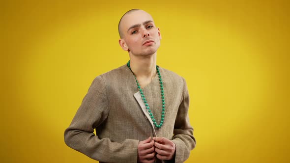 Medium Shot of Male Queer Buttoning Female Jacket Looking at Camera