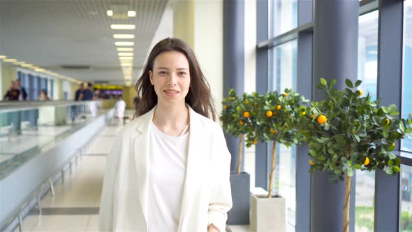 Young Woman with Baggage in International Airport Walking with Her Luggage. Airline Passenger in an