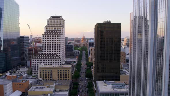 Aerial view towards the Texas State Capitol, sunset in Austin, USA - zoom in, drone shot