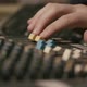 Mens hand pulling up knobs of audio mixer in studio - VideoHive Item for Sale