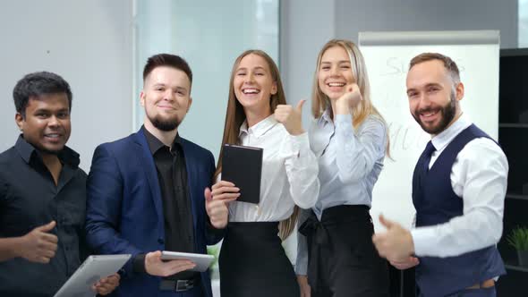 Group of Smiling Young Multi Ethnic Business People Enjoying and Showing Gesture Cool Thumbs Up