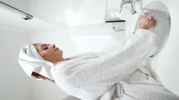 Cute Woman Washing Hands with Soap at Home