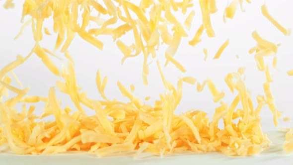 Super Slow Motion Shot of Grated Cheese Falling on White Background at 1000 Fps