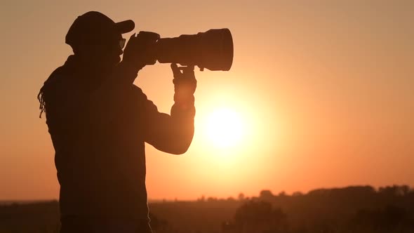 Photographer Taking Pictures with Telephoto Lens