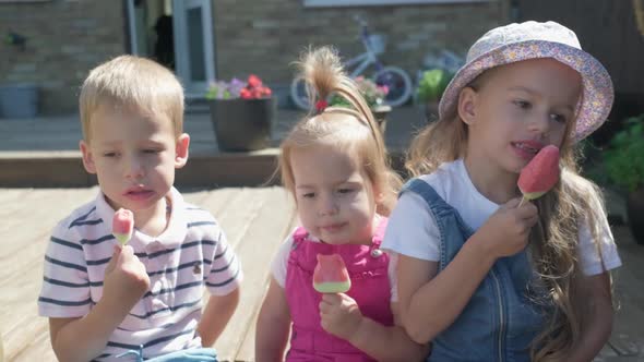 Three Cute Little Children Enjoys Delicious Ice Cream Cone