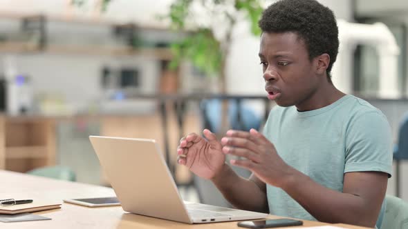 Loss, Young African Man Reacting To Failure on Laptop