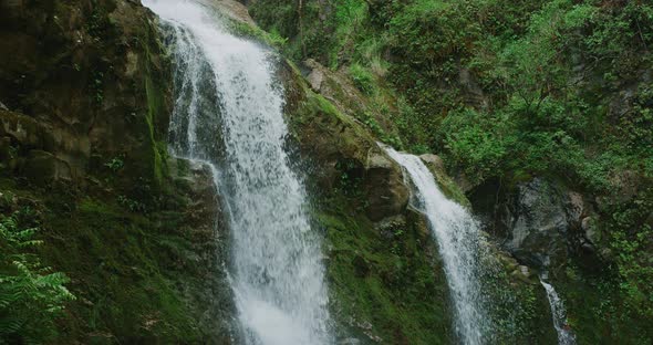 Three epic waterfalls flowing in slow motion in natural jungle setting