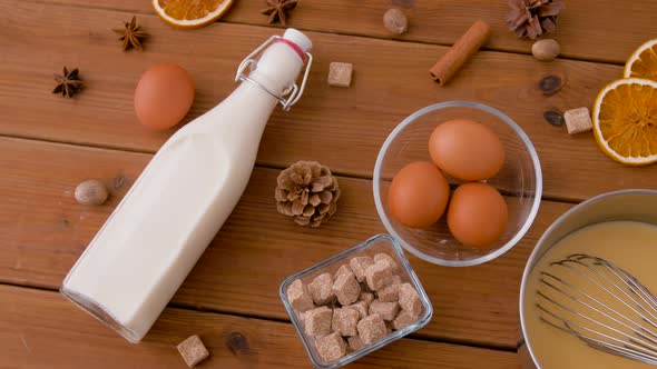 Pot with Eggnog, Ingredients and Spices on Wood