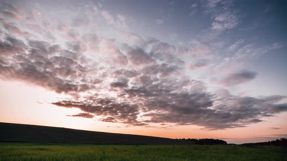 Beautiful sunset time lapse video near the hill in the fields.