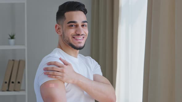 Happy Satisfied Ethnic Guy Arab Man Hispanic Patient Male Posing Indoors Wears White Tshirt Shows