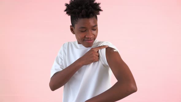 African American Teenager Showing COVID19 Vaccine Bandage Merrily