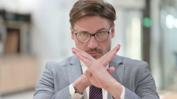 Portrait of Angry Businessman Stop Sign with Crossed Arm