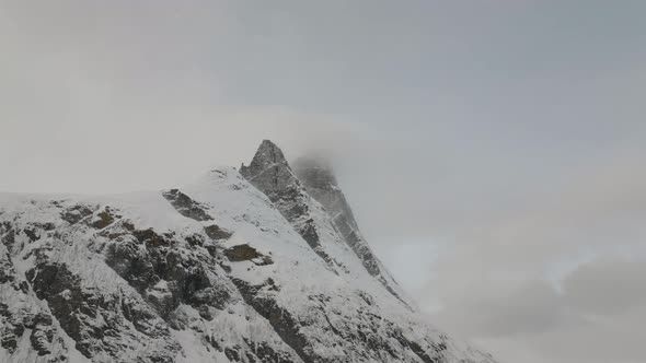 Ascent towards the snow covered Otertinden mountain in northern Norway. Summit hidden in the clouds.