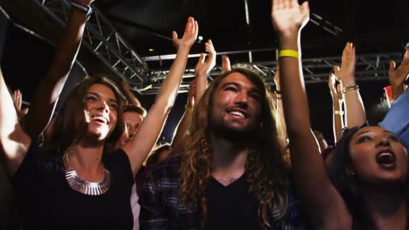 Group of people dancing at a concert 4k