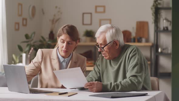 Female Financial Advisor Giving Consultation to Senior Man