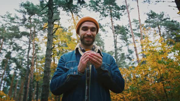 Happy Man Found Zen and Tranquility Enjoying Hot Tea in Noiseless Autumn Forest