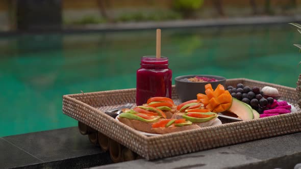 Closeup Shot of a Personal Breakfast on a Floating Table in a Private Swimming Pool