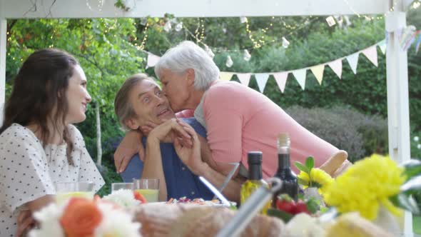 Family eating outside together in summer