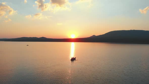 People Sitting in Boats on the River on Sunset