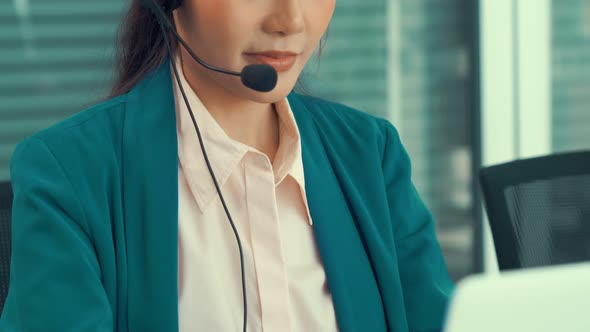 Businesswoman Wearing Headset Working Actively in Office