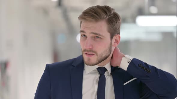 Young Businessman Having Neck Pain