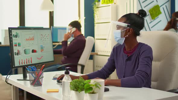 African Workers with Face Mask Writing on Pc and Looking on Camera