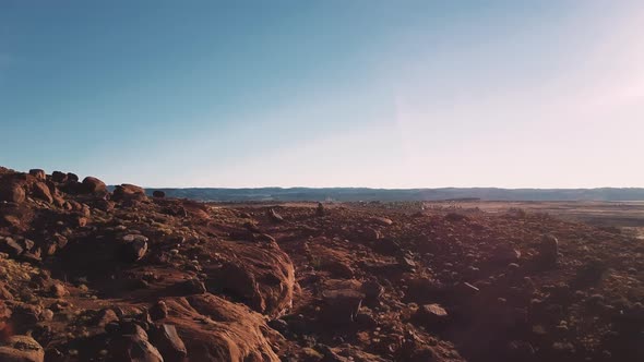 Drone Flying Low Above Ground with American Sandstone Landscape Covered with Rocks and Stones in