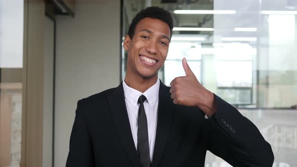 Thumbs Up by Black Businessman in Office