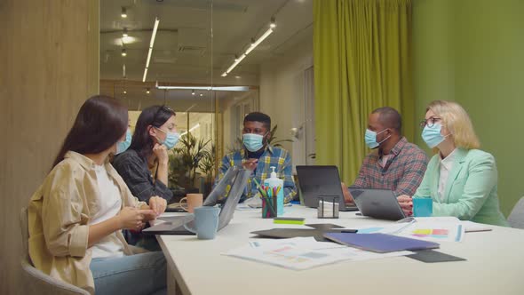 Diverse Businesspeople Disinfecting Hands at Office