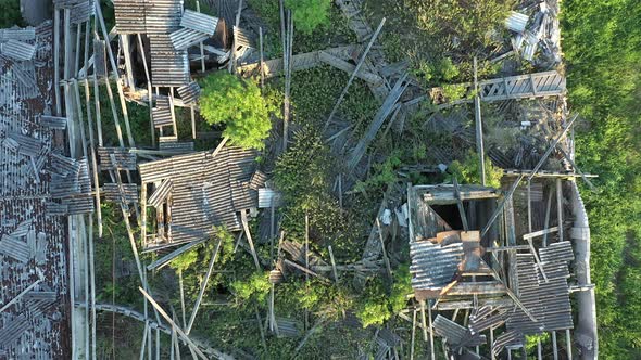 Aerial Shot of a Ruined Rooftop of a Soviet Farm Building