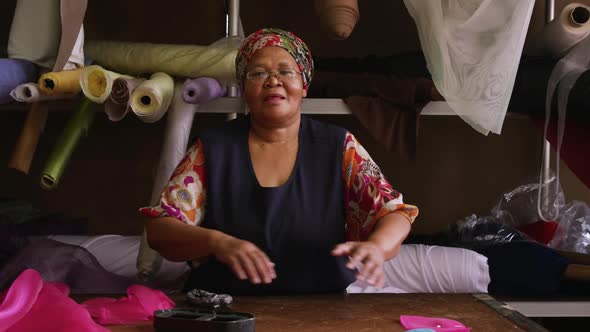 Mixed race woman working at a hat factory