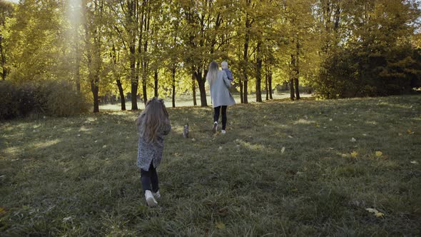 Family Walk in the Autumn Park