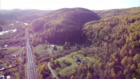 View of a Beautiful Forest Village Village Railway and River Along the Forest Bird's Eye View of the