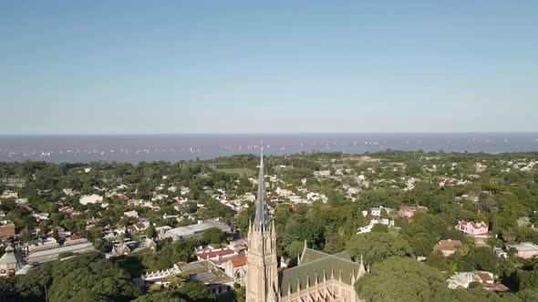 Aerial of San Isidro city revealing the Cathedral with La Plata river behind. Dolly out