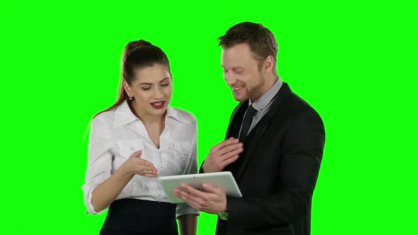 Two Office Worker Look at a Laptop Together. Online Shopping, Green Screen