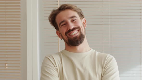 Portrait of a Smiling Young Spanish Man Looking at Camera in an Apartment
