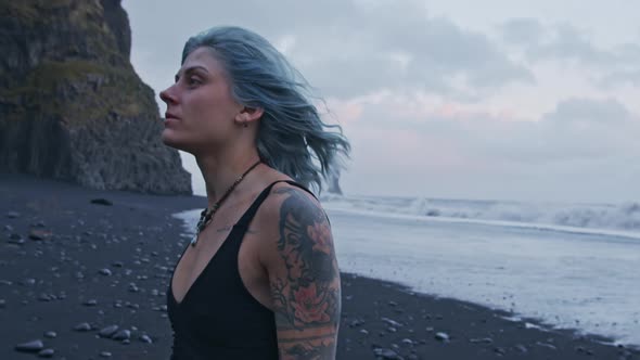 Windswept Blue Haired Girl On Black Beach