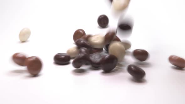 Chocolate kruitnoten (pepernoten): traditional Dutch candy. Falling slow motion. White background