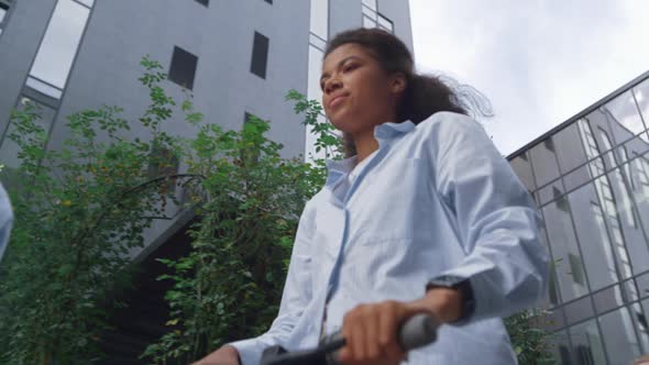 Portrait Businesswoman Riding Electric Scooter Commuting to Office City Street