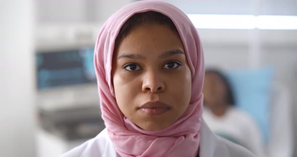 Closeup of Muslim Female Doctor Looking at Camera Working at Hospital