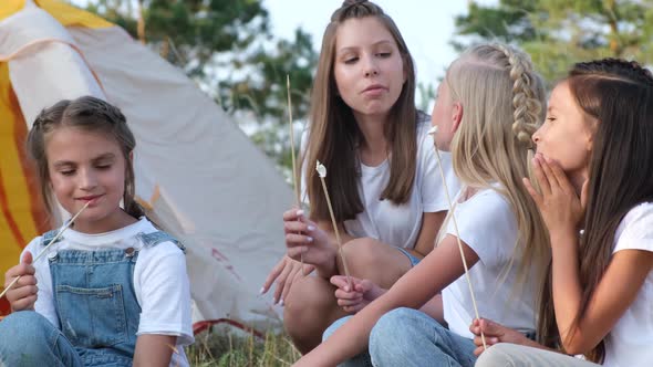 Teen Children Fry Marshmallows By the Fire on a Picnic They Have Fun in a Summer Camp