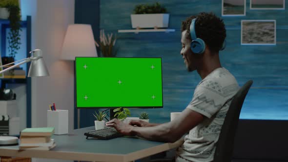 Entrepreneur Working on Computer with Horizontal Green Screen