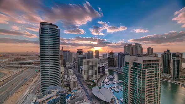 Modern Skyscrapers and Water Channel with Boats of Dubai Marina at Sunset Timelapse United Arab