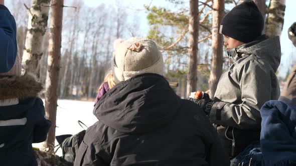 Multi generation family hiking in winter, cooking dinner in the forest