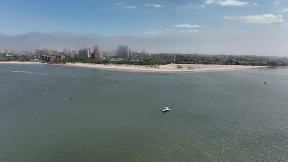 An aerial view over Gravesend Bay in Brooklyn, NY on a beautiful day with blue skies and white cloud