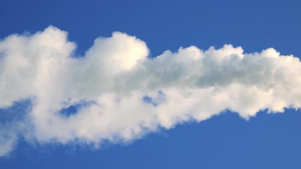 Closeup on a Smoke From a Smokestack - the Clear Blue Sky in the Background