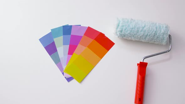 Paint Roller and Color Palette on White Background