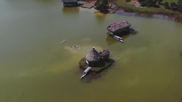 4k daytime aerial drone view looking out to a small house over the lake at Laguna de los Milagros (M