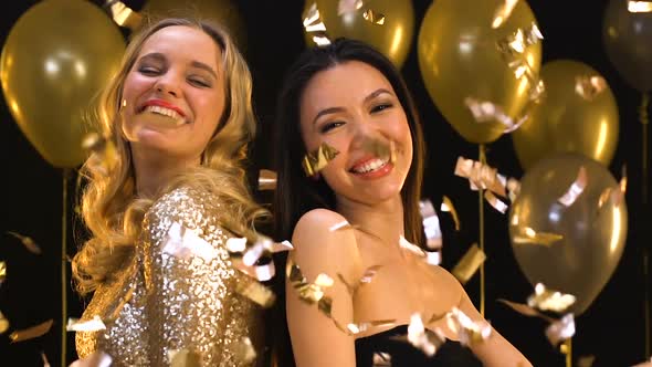 Multiracial Women Smiling and Having Fun at Party Under Falling Confetti